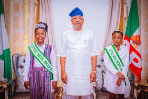 Governor Ododo with Little Miss Nigeria 2026 winner Queen Aisha Audu and Queen Pristine in Lokoja.